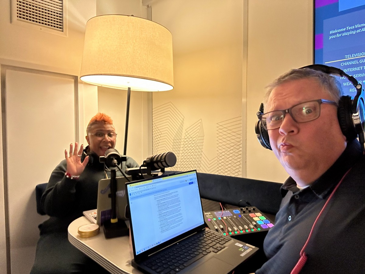 Keith Johnston and Tess Vismale recording an episode of Event Tech Pull Up with microphones, headphones, and a laptop